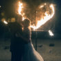 couple kissing in front of heart of fire