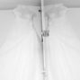 the wedding dress hanging in front of mirror