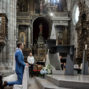 bride and groom receive benediction from the priest